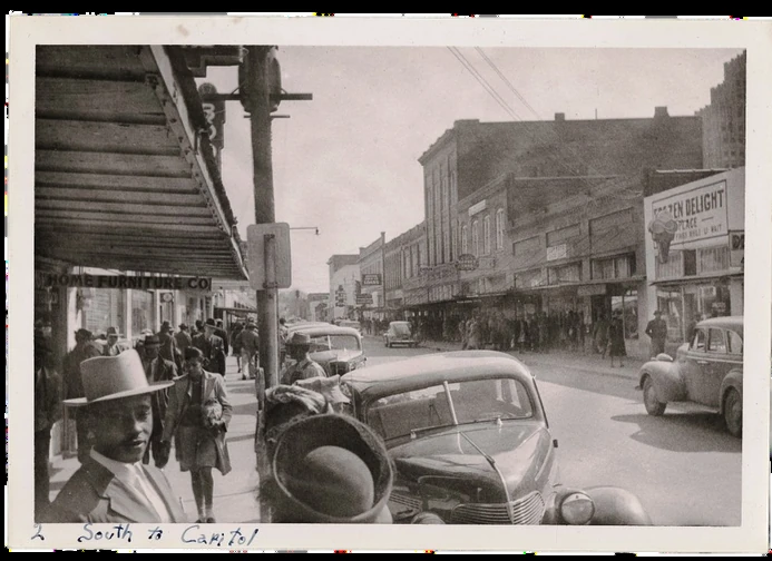 Historic street scene on Farish Street with pedestrians, cars, and storefronts