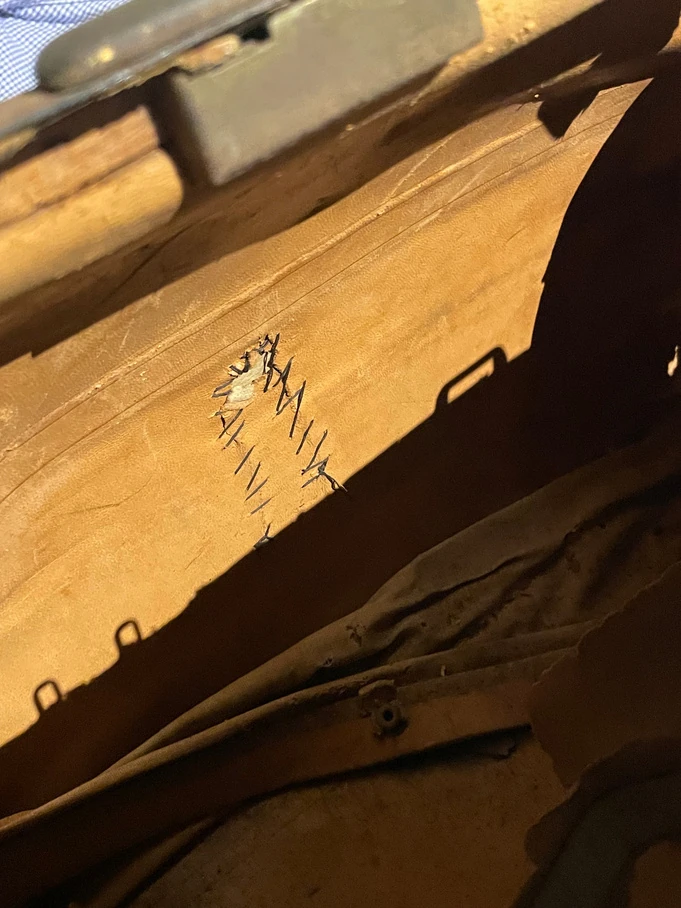 Close-up of worn leather and stitching inside a medical bag