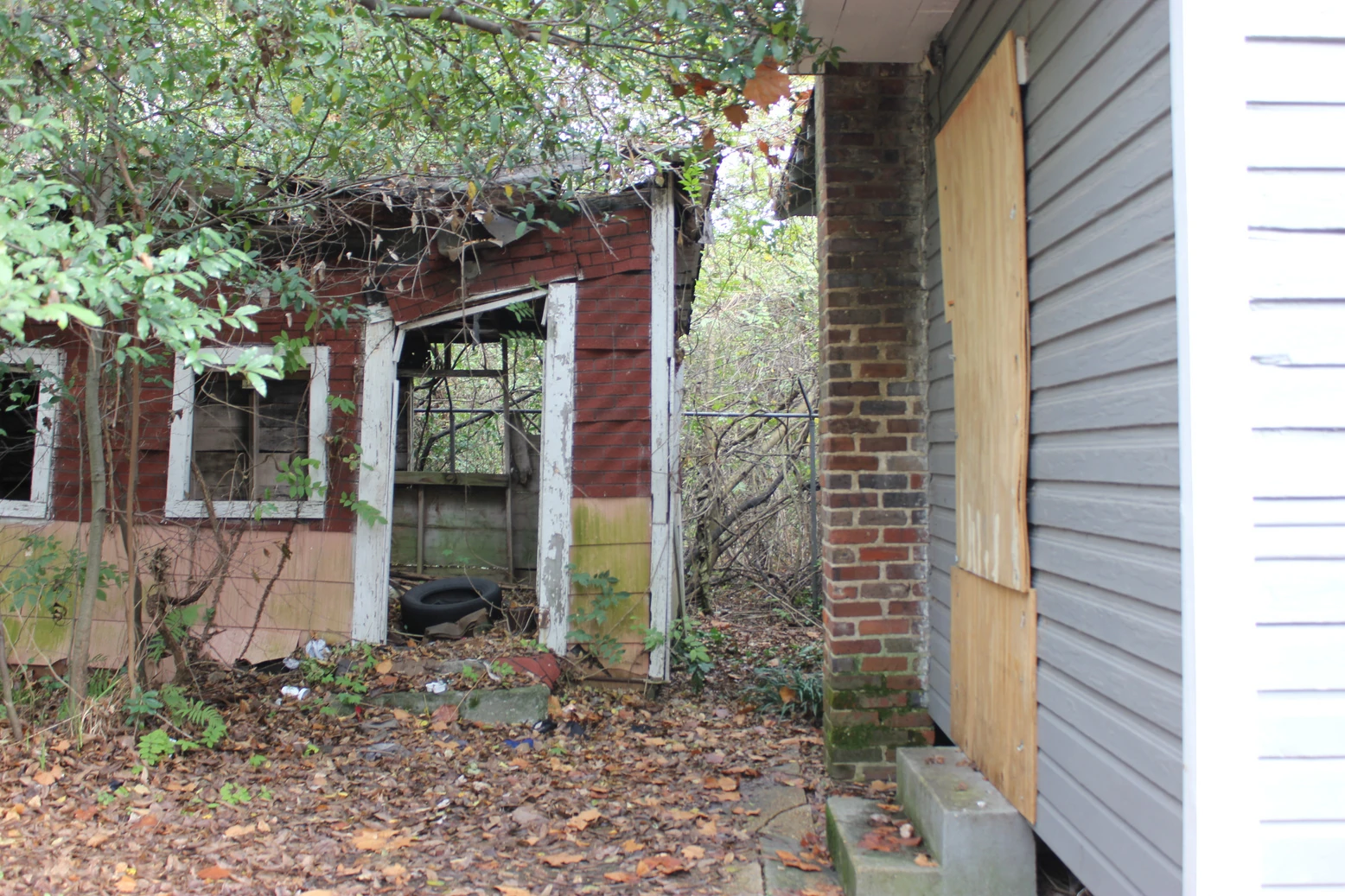 Small weathered washhouse standing behind the Scott Ford Houses