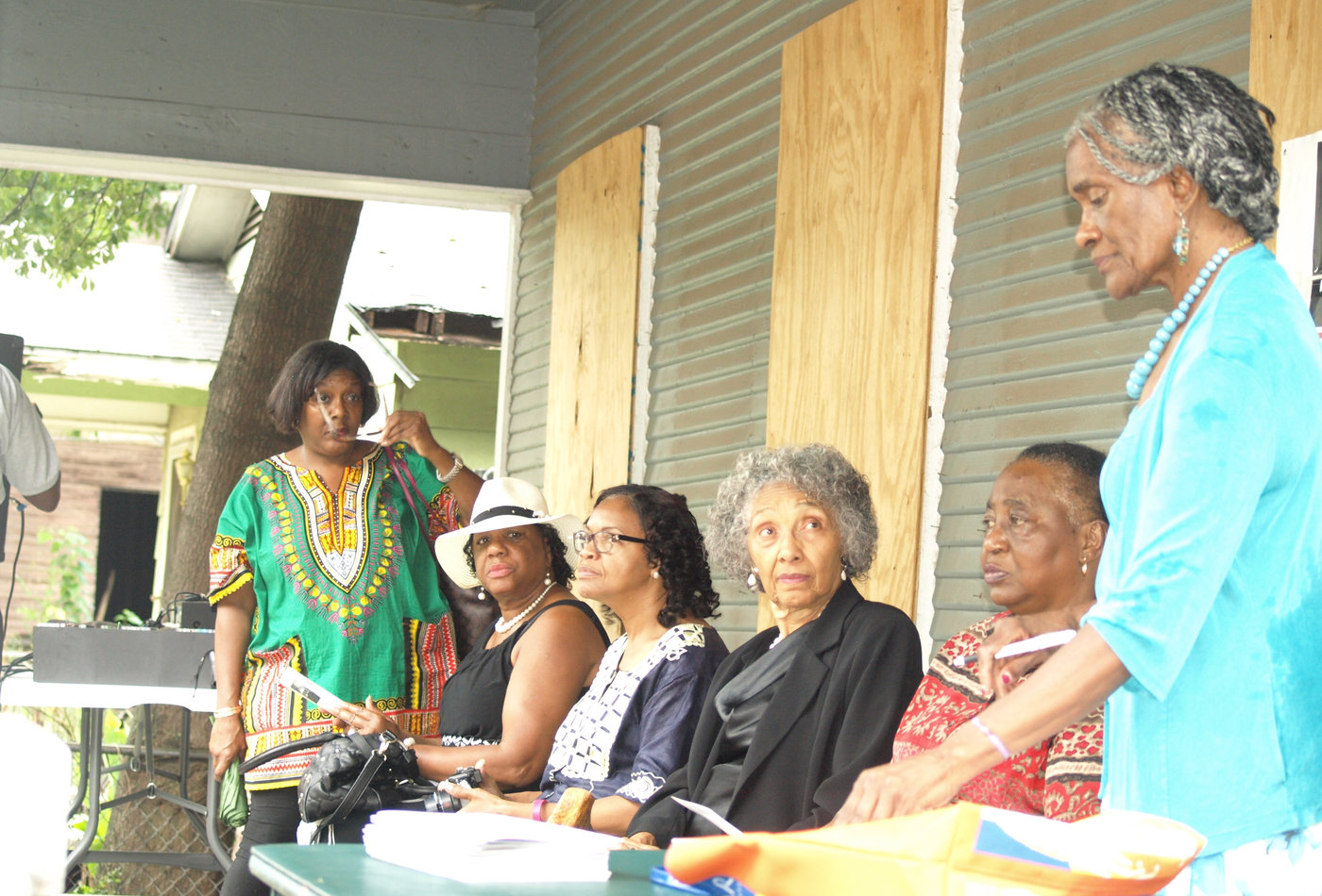 Community members gathered on the porch of a Scott Ford House