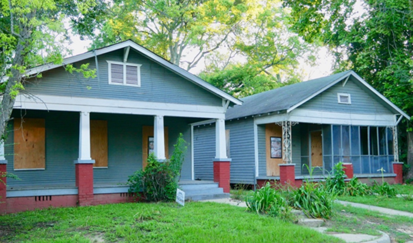 The two gray Scott Ford Houses with front porches and a shared drive